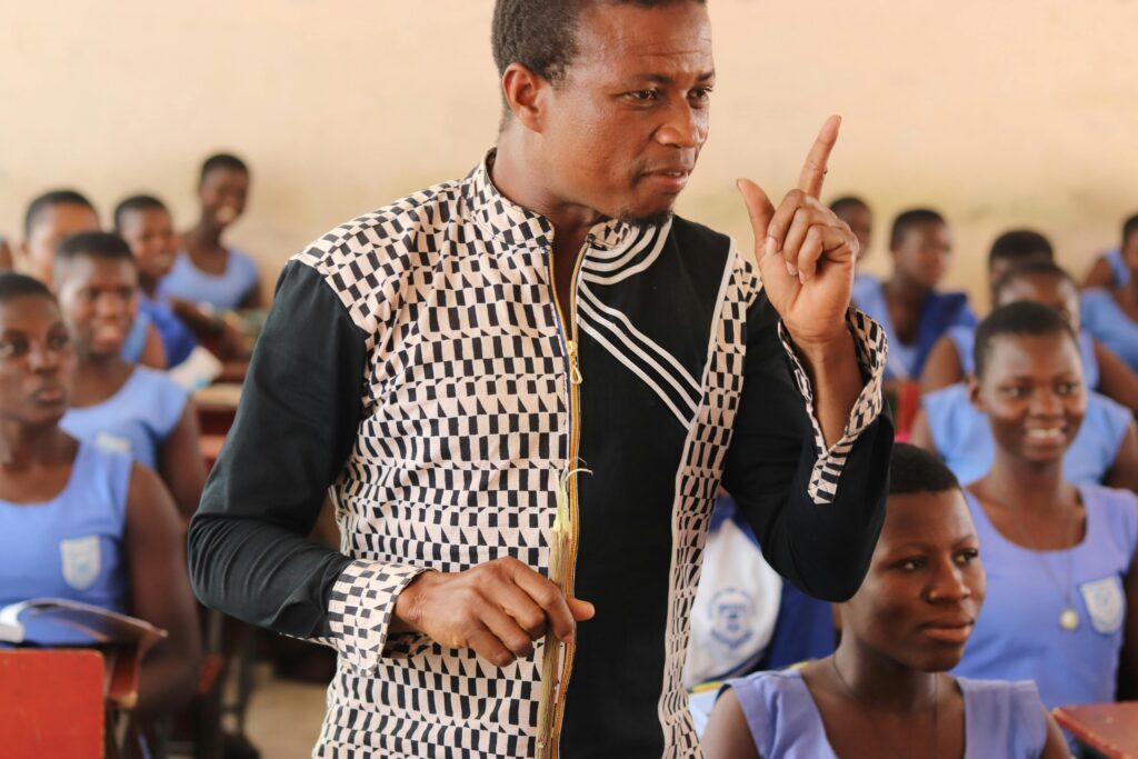 Engaging teacher in a vibrant classroom setting in Ghana. Inspiring education.